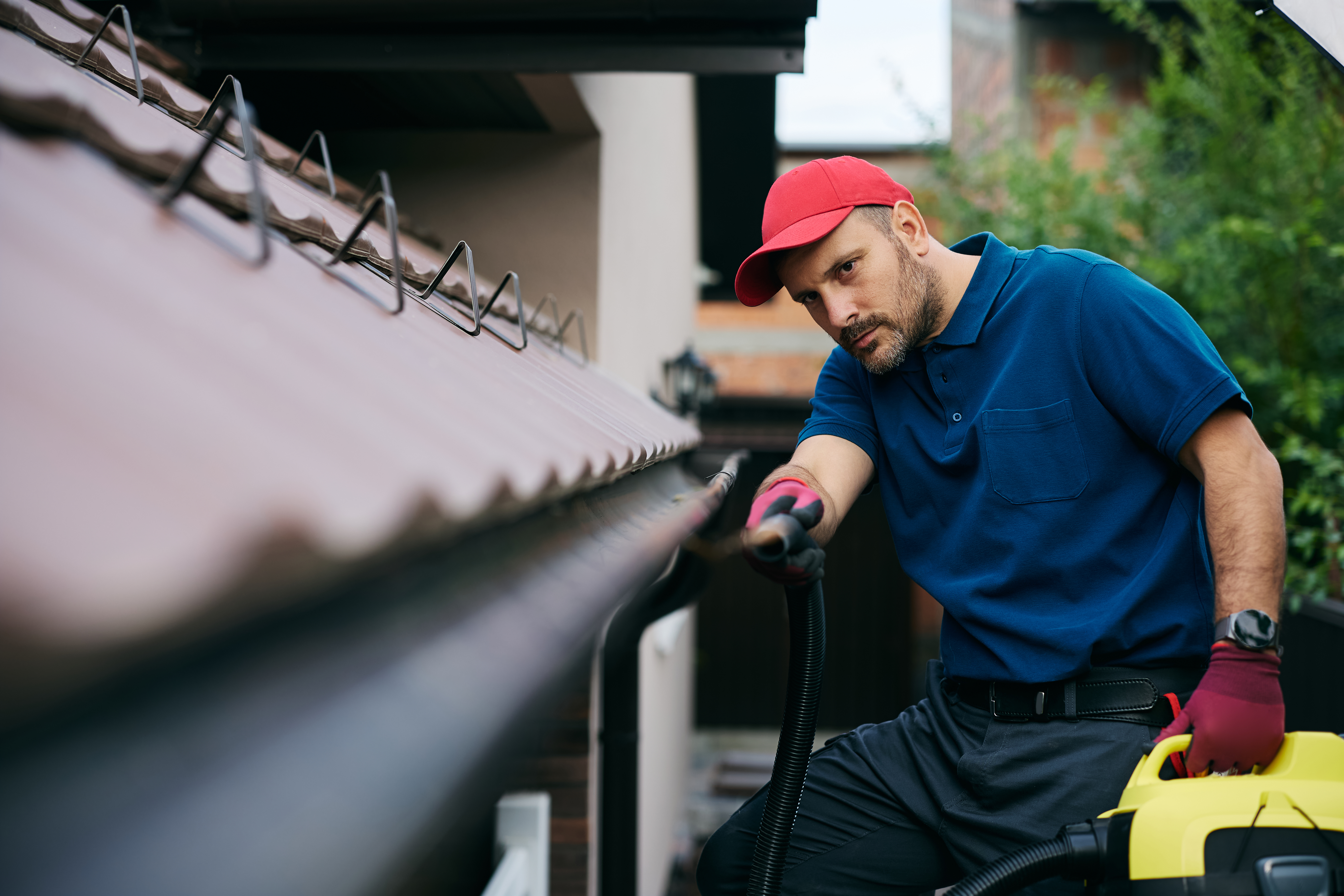 Roof and gutter cleaning service in progress